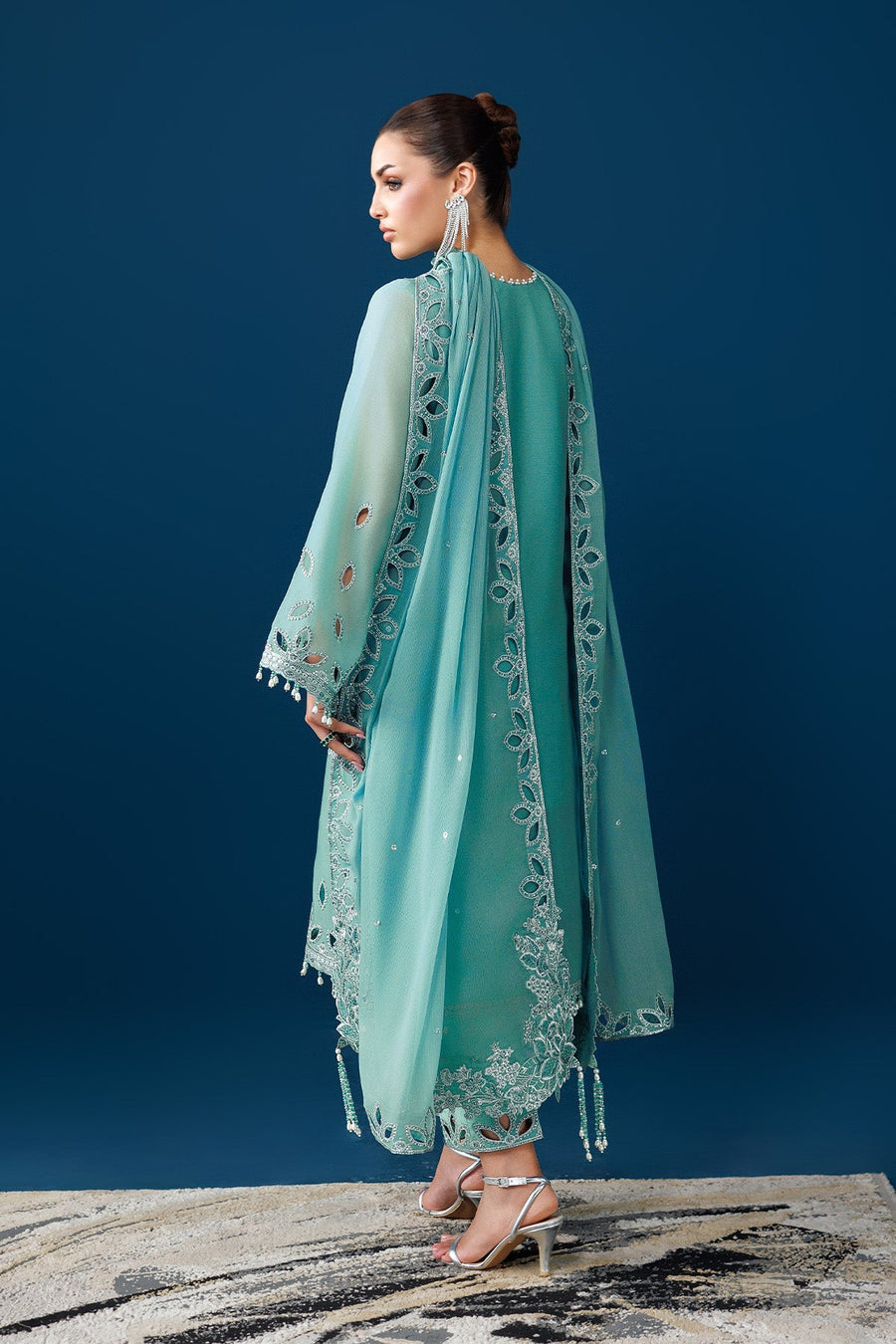 Back view showing embroidery and pearl tassels on sleeves and dupatta of the Pakistani suit