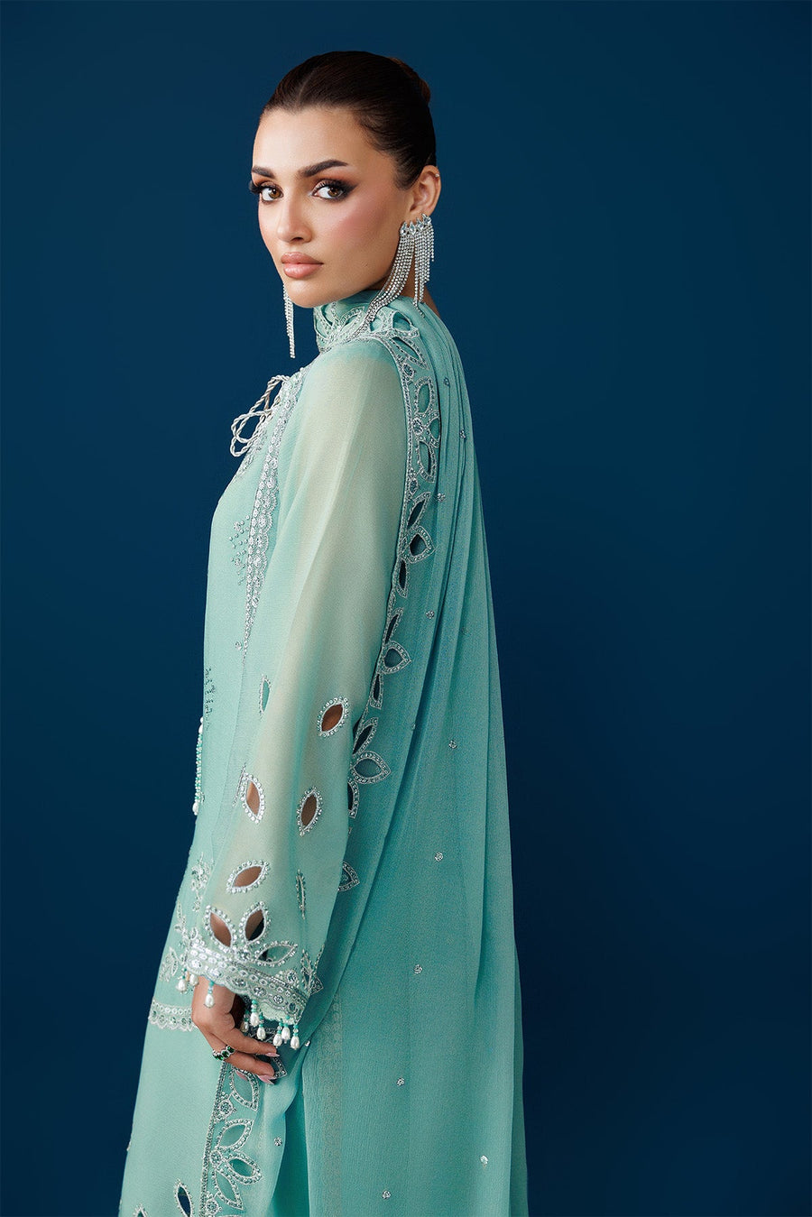 Close front view of the drawstring neckline with pearl tassels and floral embroidery on the suit