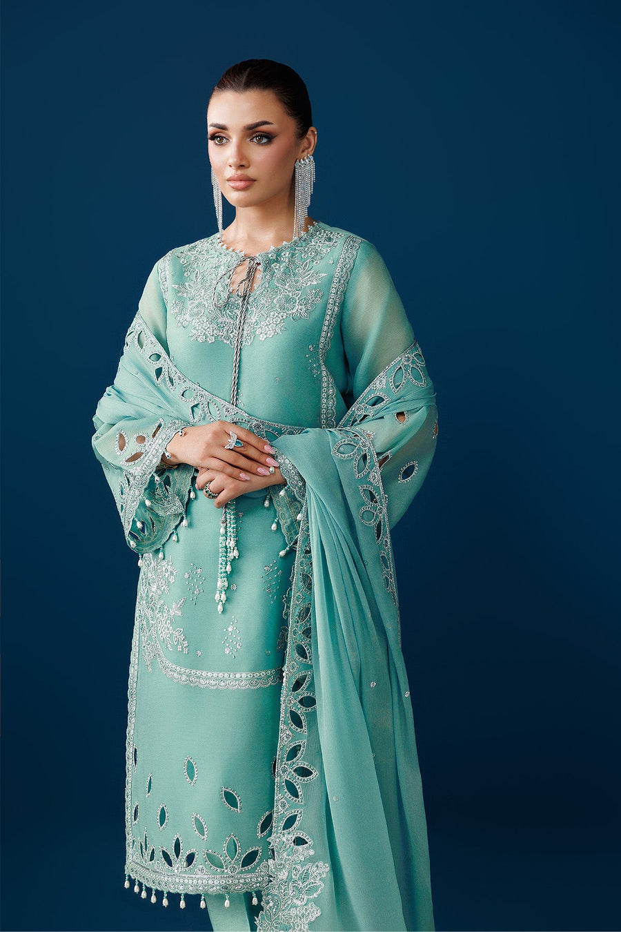 Side view highlighting cutwork on the sleeve and detailed embroidery on the suit fabric
