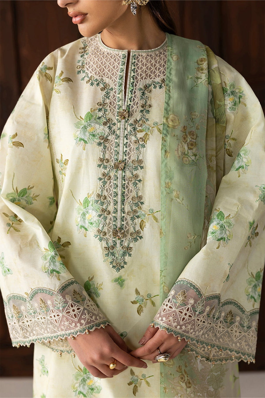 Close-up of detailed neckline embroidery and lace sleeve cuffs of lawn shirt