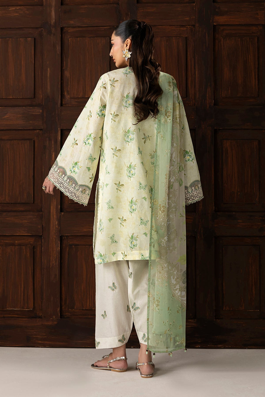 Back view of embroidered lawn suit showing floral patterns and dupatta draped over shoulder