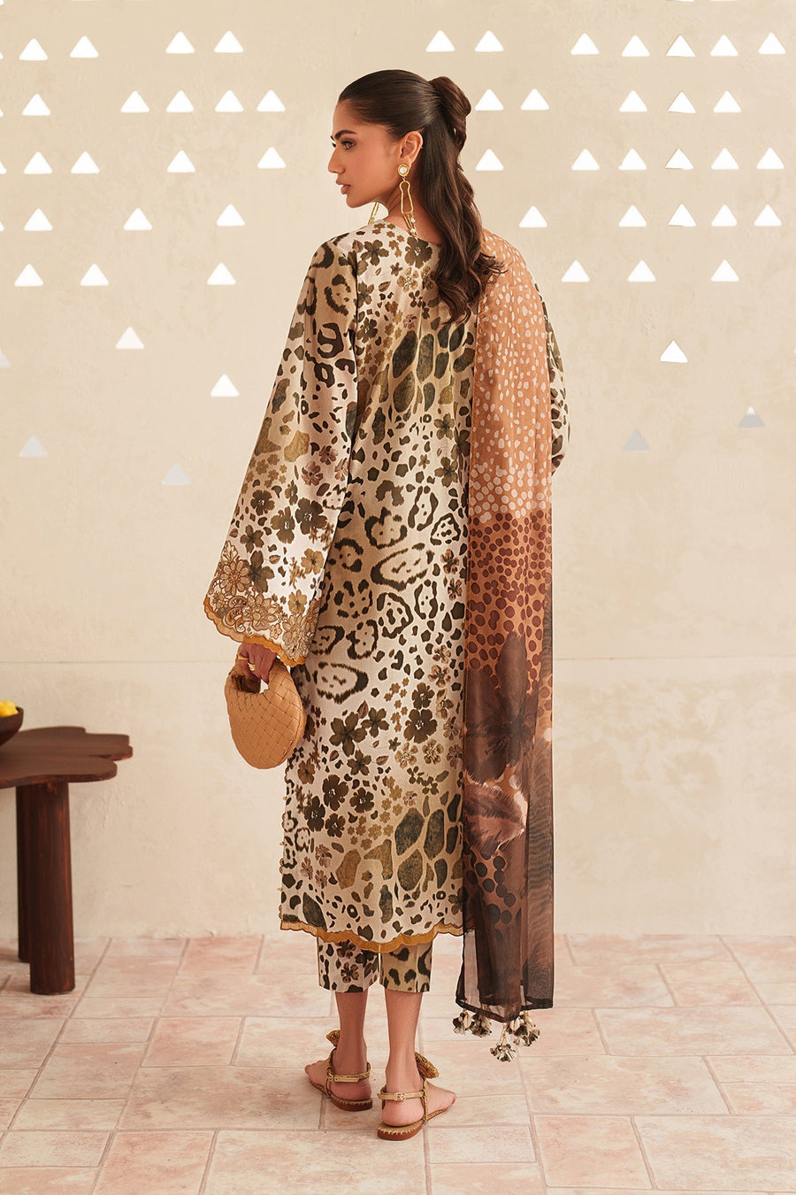 Back view of embroidered lawn suit showing full print pattern and solid dupatta with tassels