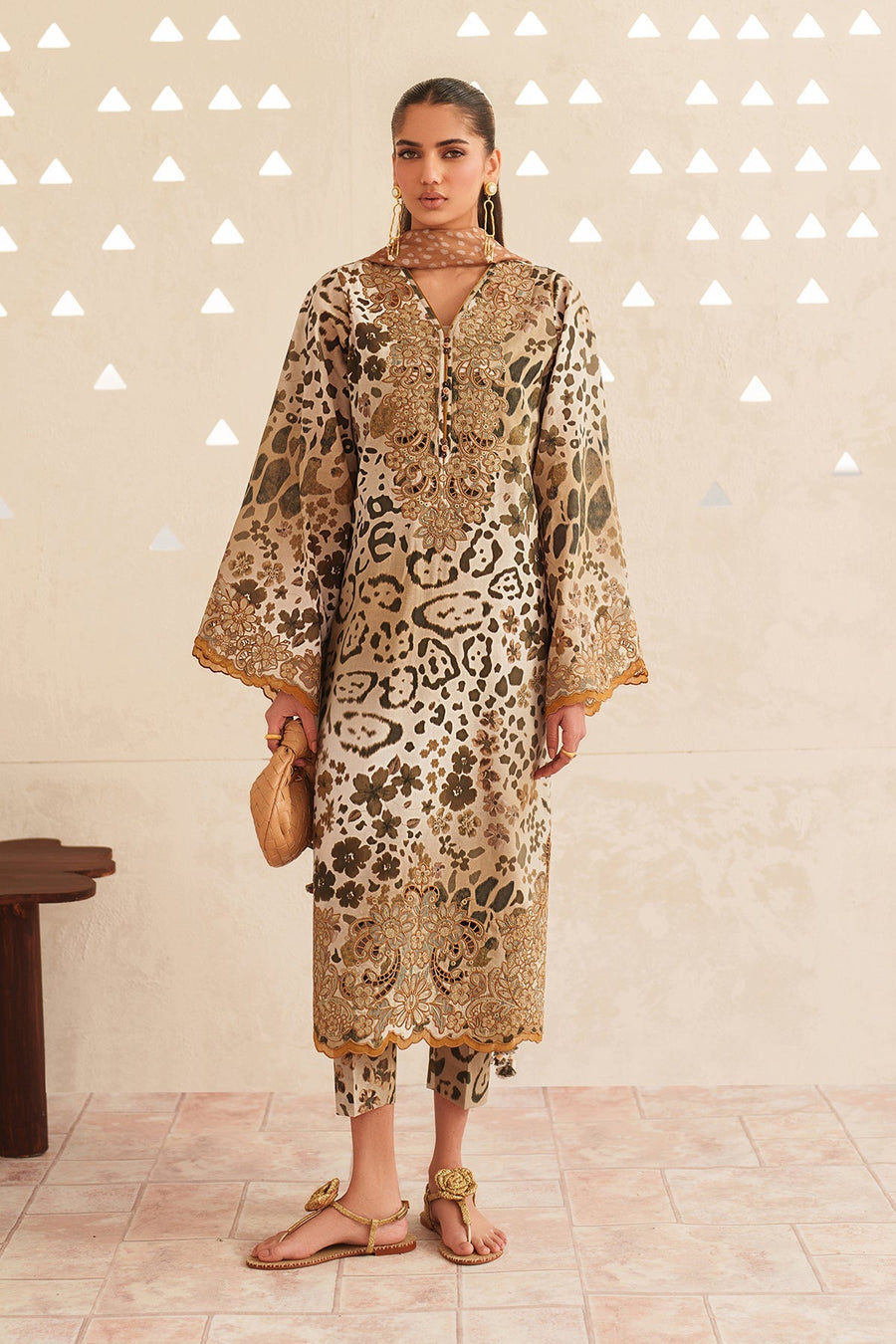 Side view of embroidered lawn suit showing detailed embroidery on sleeves and neckline with patterned dupatta