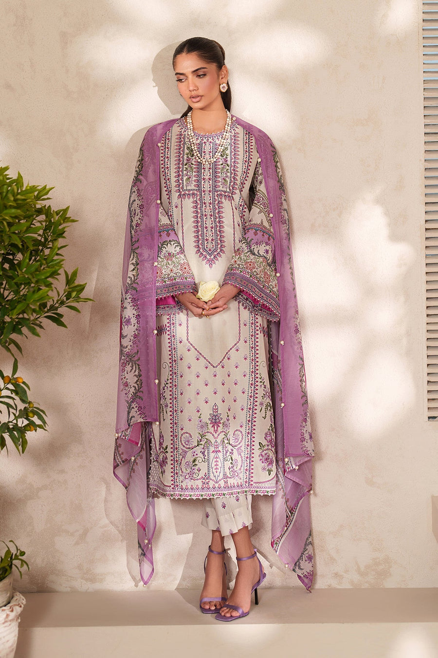 Close-up side angle capturing intricate embroidery on the sleeves and border of the lavender chiffon dupatta worn over cream lawn suit.