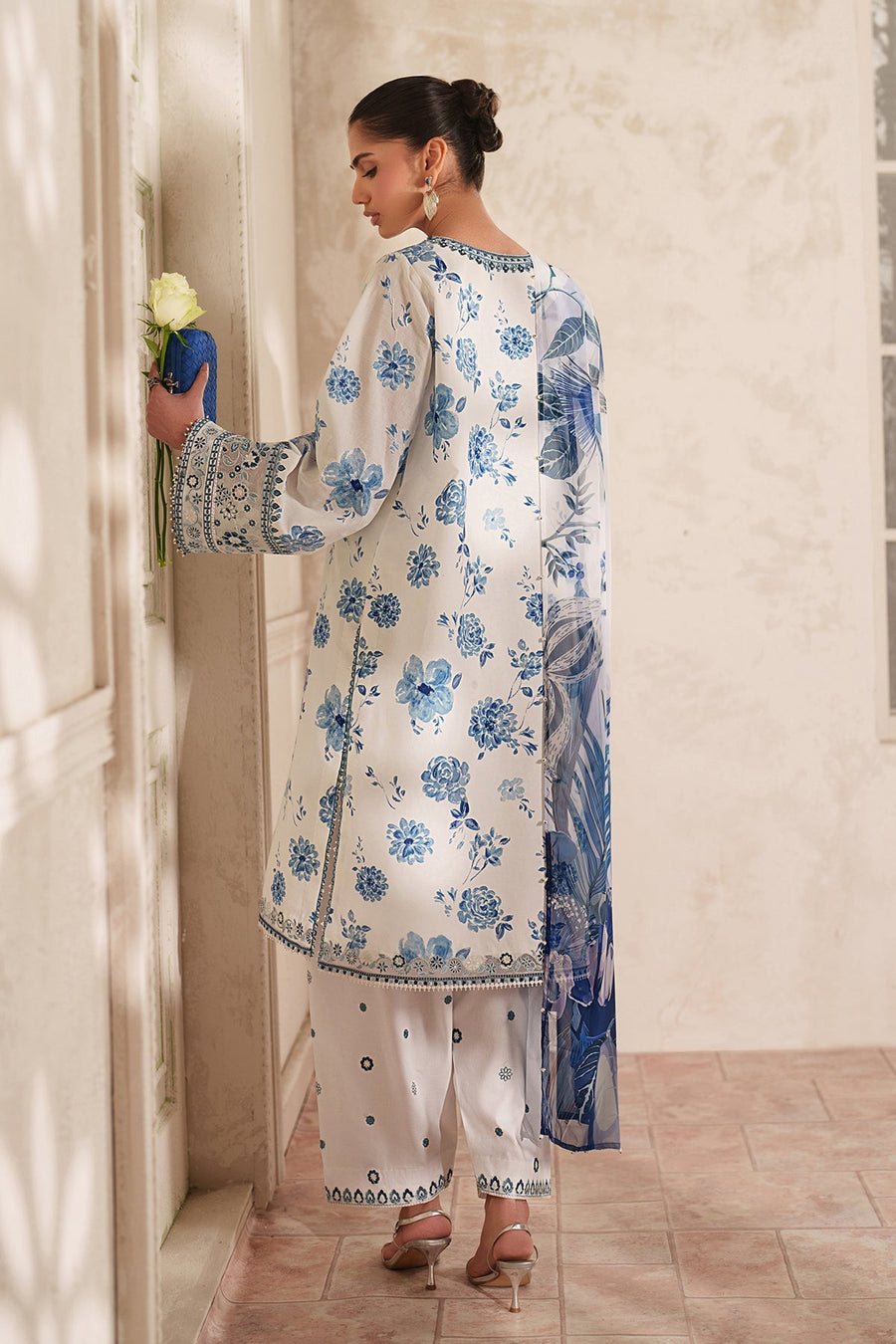 Back view showcasing the floral print and embroidery details on sleeves and tunic hem of the outfit