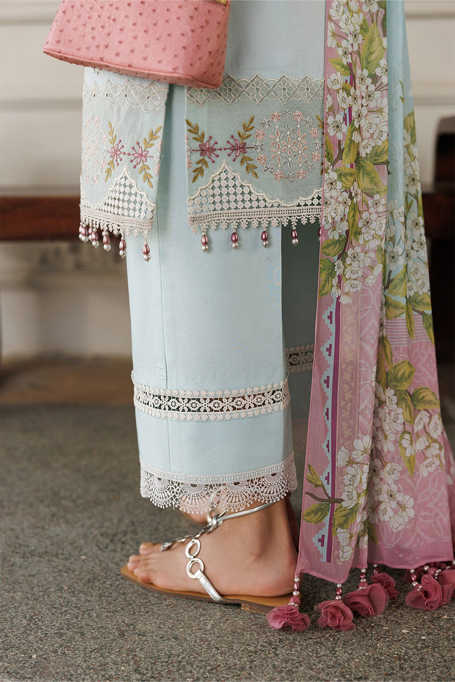 Close-up of embroidered lawn shirt front with floral patterns and pearl embellishments