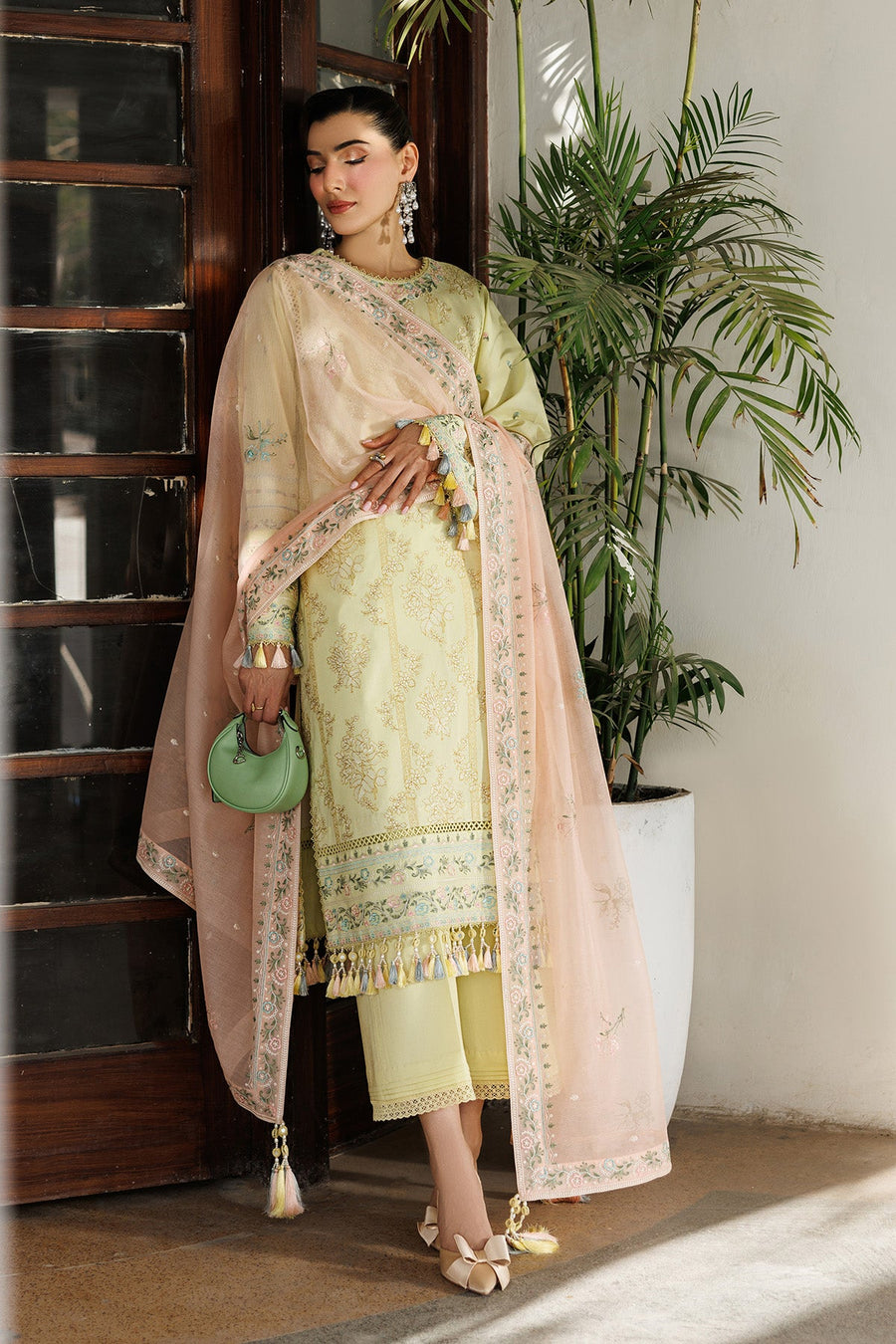 Close-up side view of pastel pink embroidered dupatta and yellow lawn shirt with floral embroidery