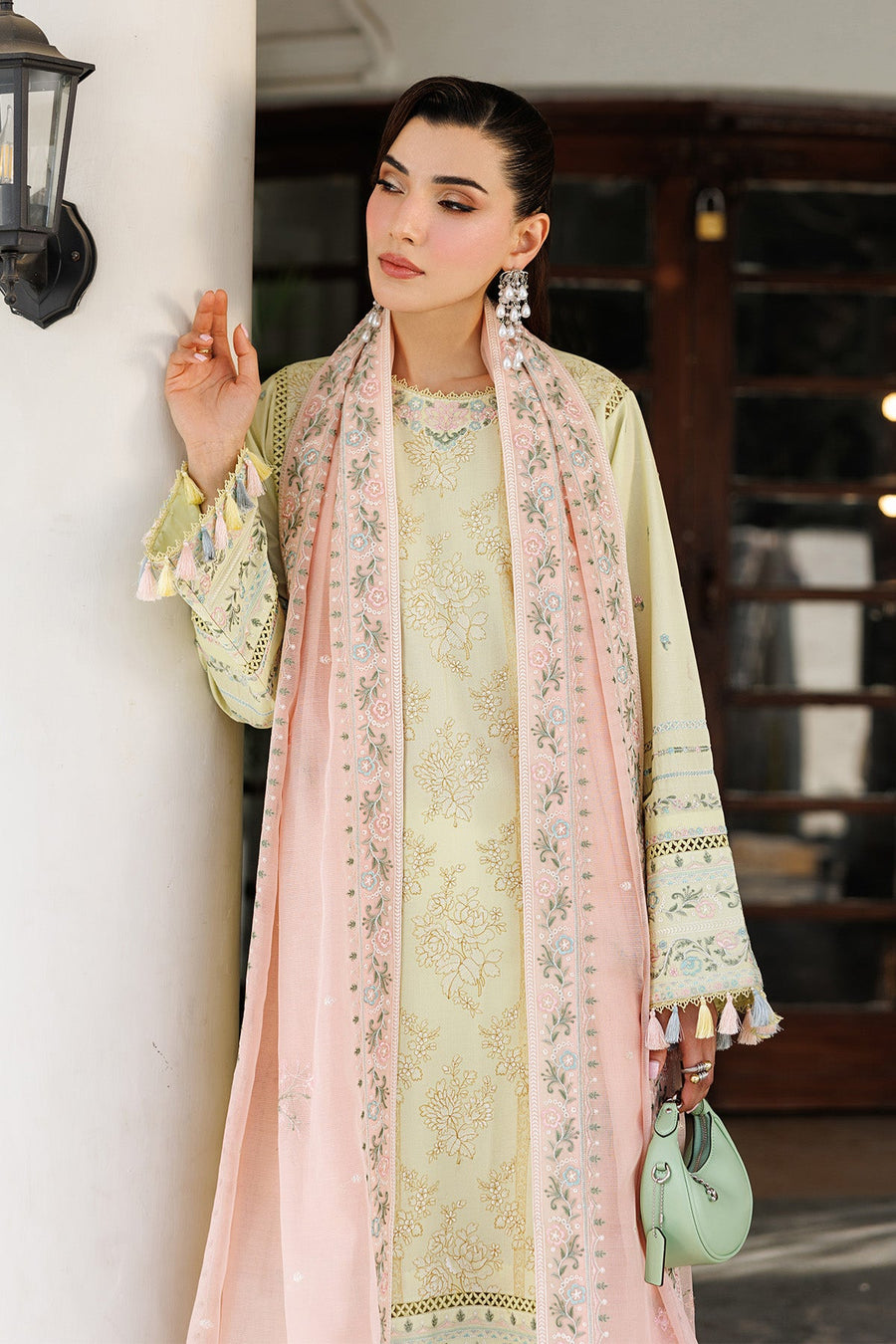 Front view of woman in yellow embroidered lawn shirt and matching trousers with embroidered pastel pink dupatta