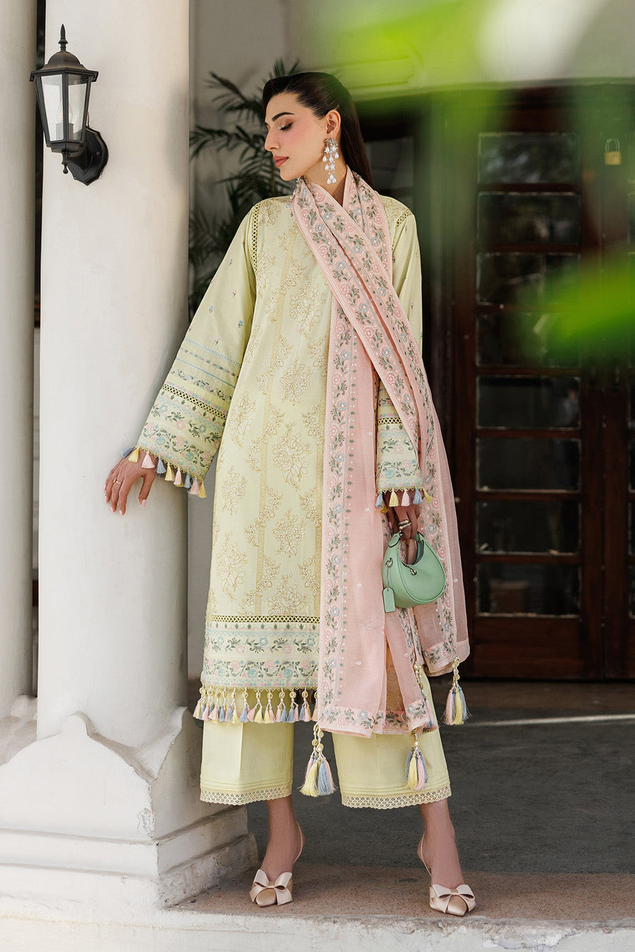 Close-up of floral embroidery and lace trim on yellow lawn shirt with pink embroidered dupatta