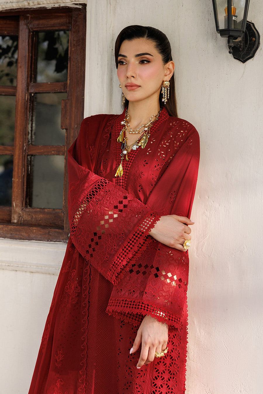 Close-up of detailed embroidery work on cuffs and tassel embellishments on red lawn suit