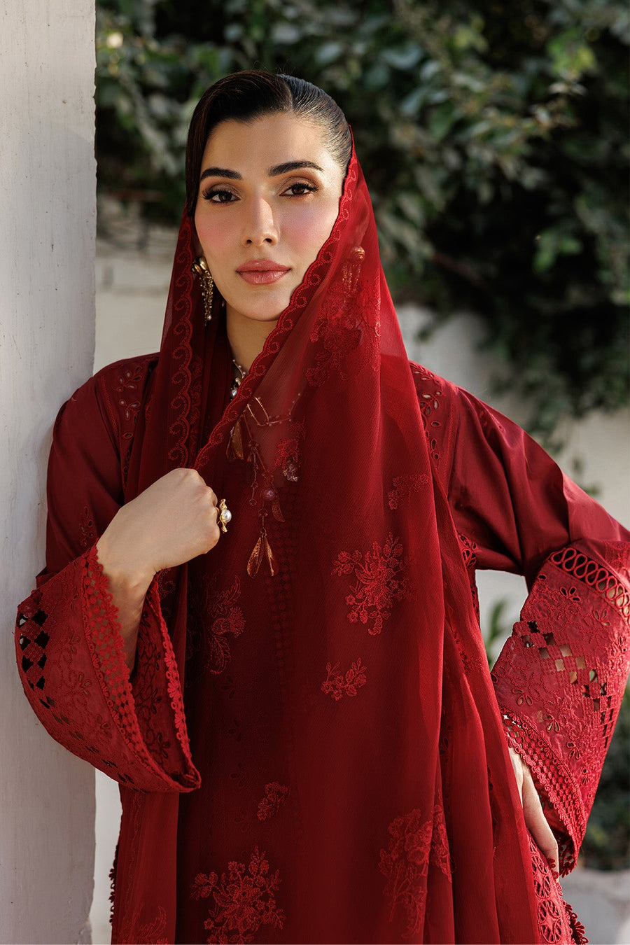 Full front view of model wearing red detailed embroidered formal lawn outfit with matching trousers