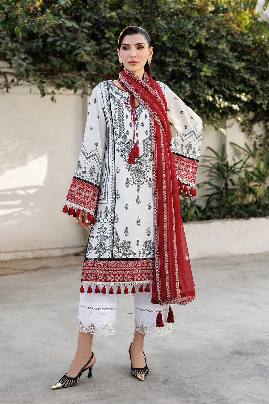 Woman wearing detailed earrings and necklace complementing embroidered lawn suit