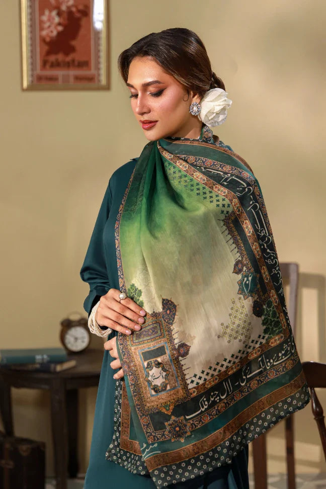 Woman wearing an elegant crinkle silk scarf with green and beige gradients and intricate calligraphy print, styled with a flower accessory in her hair.