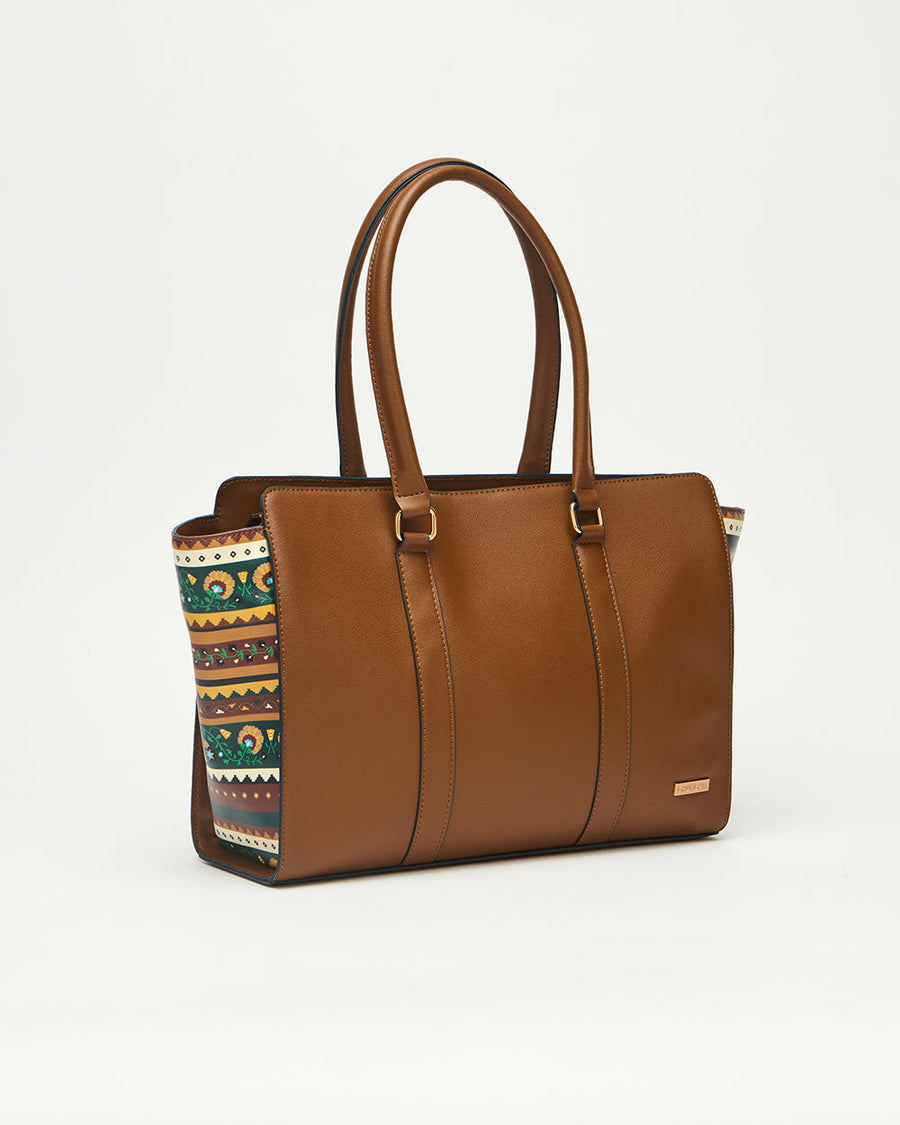 Kenya Tote bag angled on white background showing brown vegan leather front and floral decorative sides