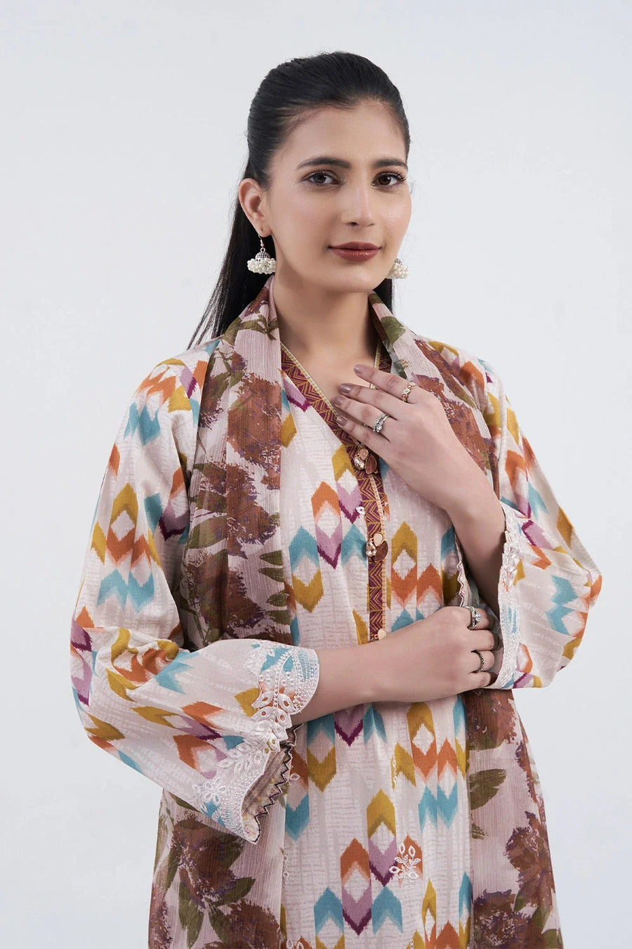 Close-up of the embroidered shirt details and colorful geometric prints with white embroidery on the sleeves