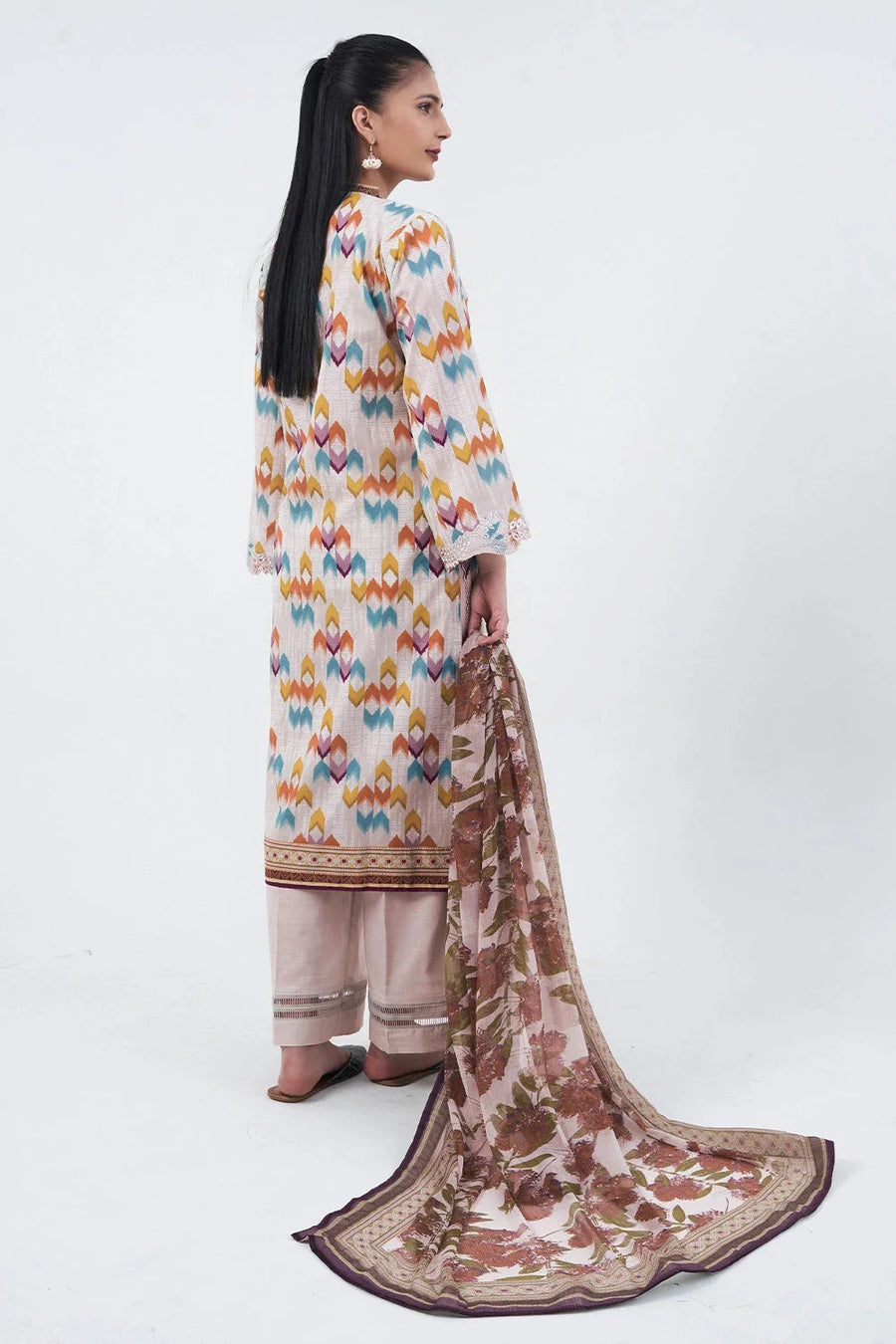 Back view of the three-piece lawn suit showing full patterned shirt and chiffon dupatta trailing on the floor