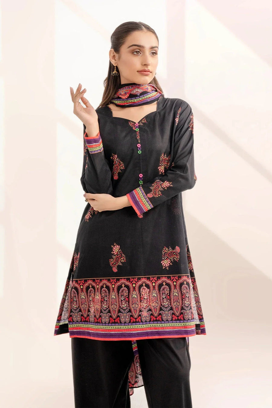 Front view close-up of black printed lawn shirt with colorful button accents on woman