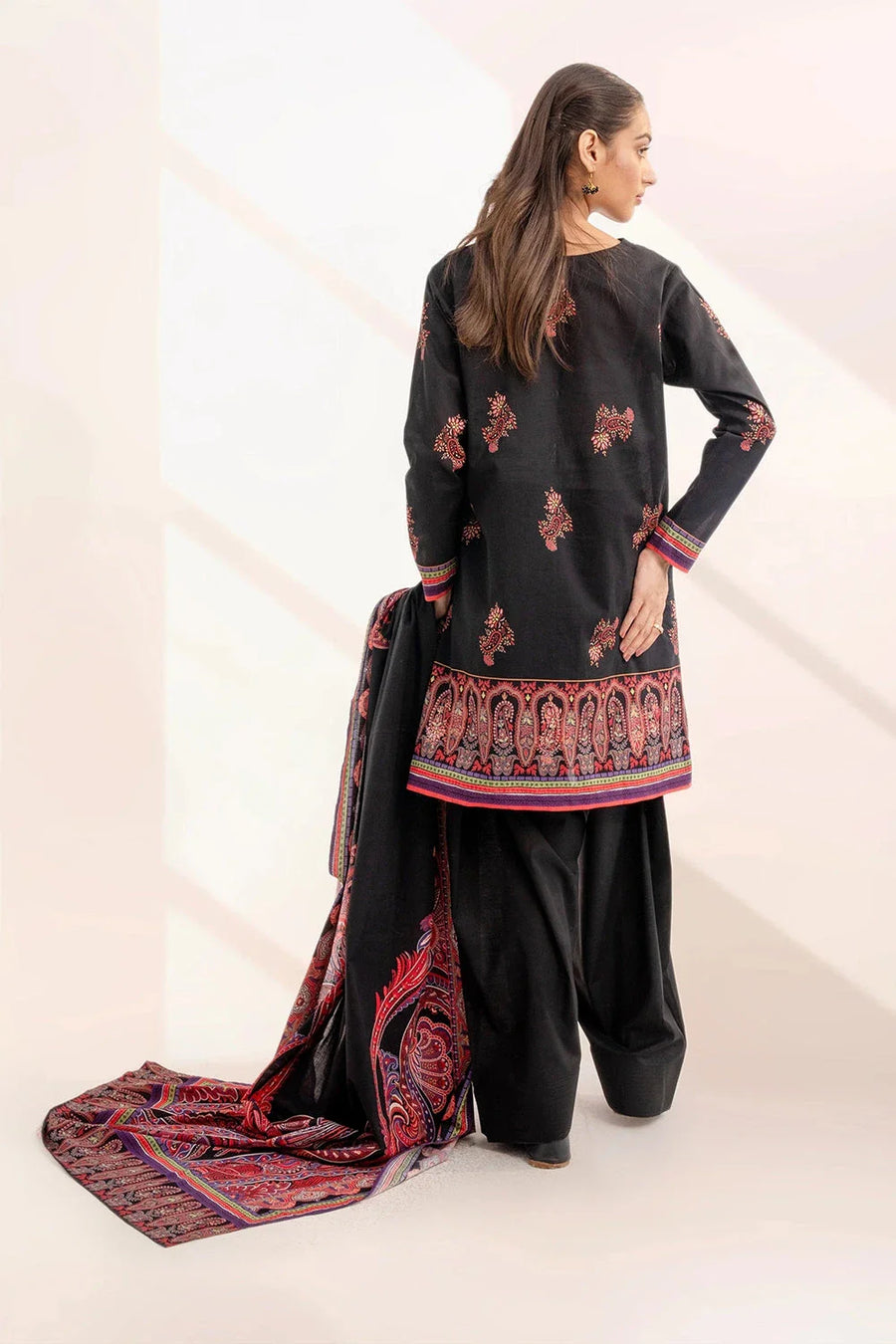Back view of black printed lawn shirt paired with black trousers and detailed dupatta on woman