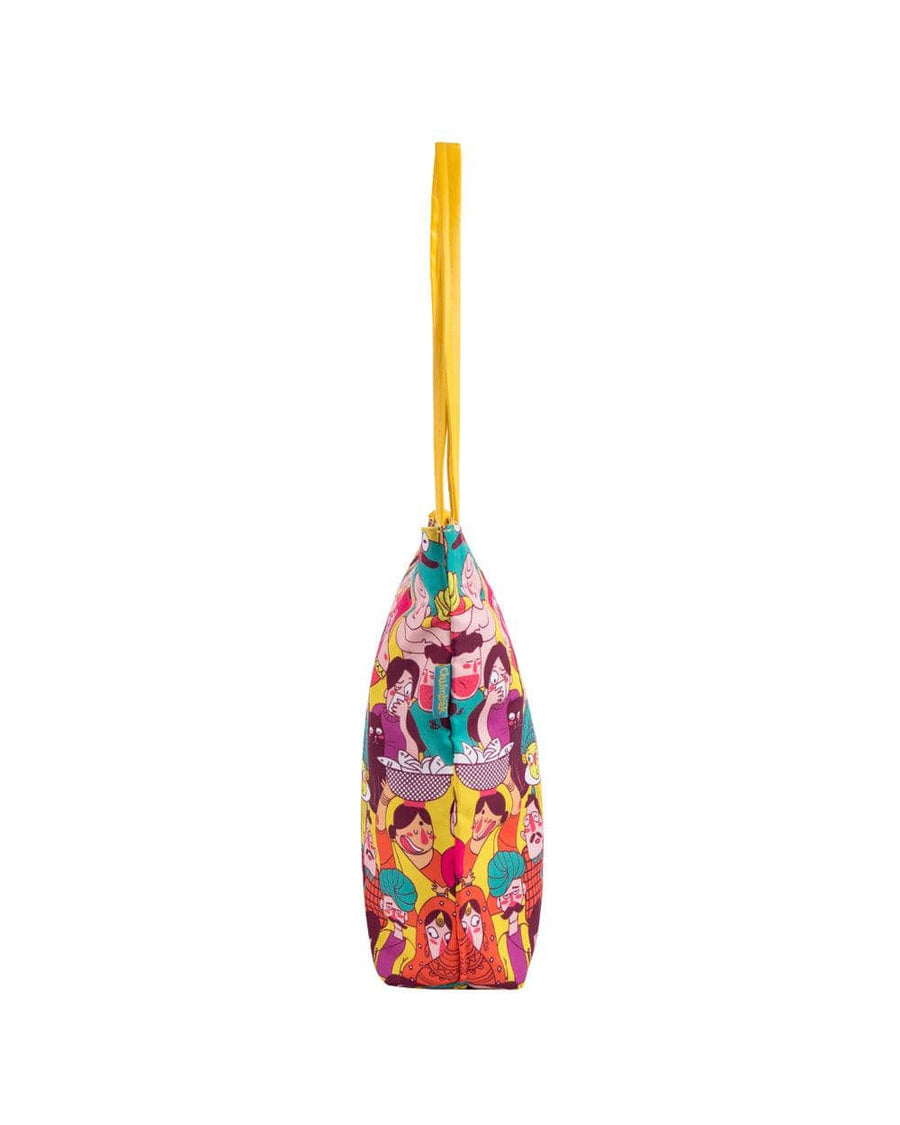 Side profile of lively tote bag displaying multicolor design and yellow handles