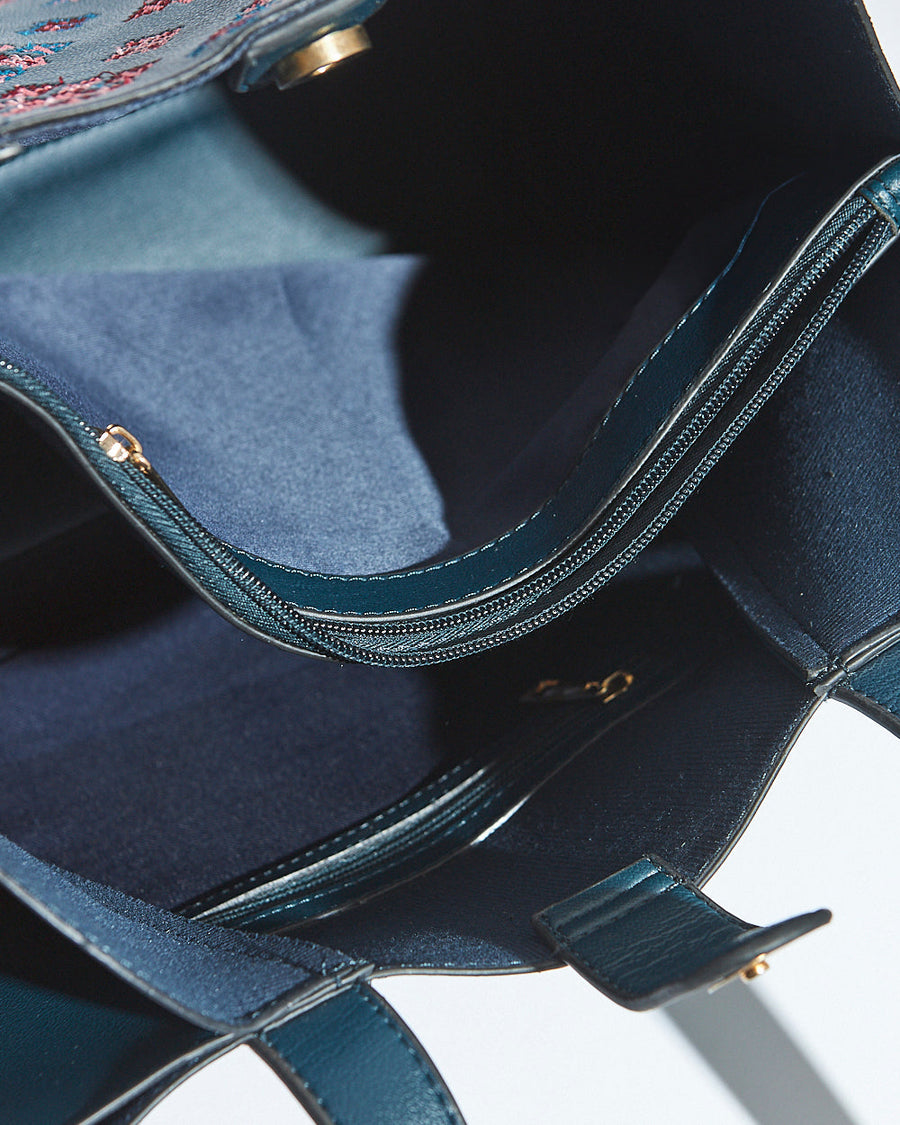 Interior view displaying the spacious compartment and secure zippered pocket inside the tote bag