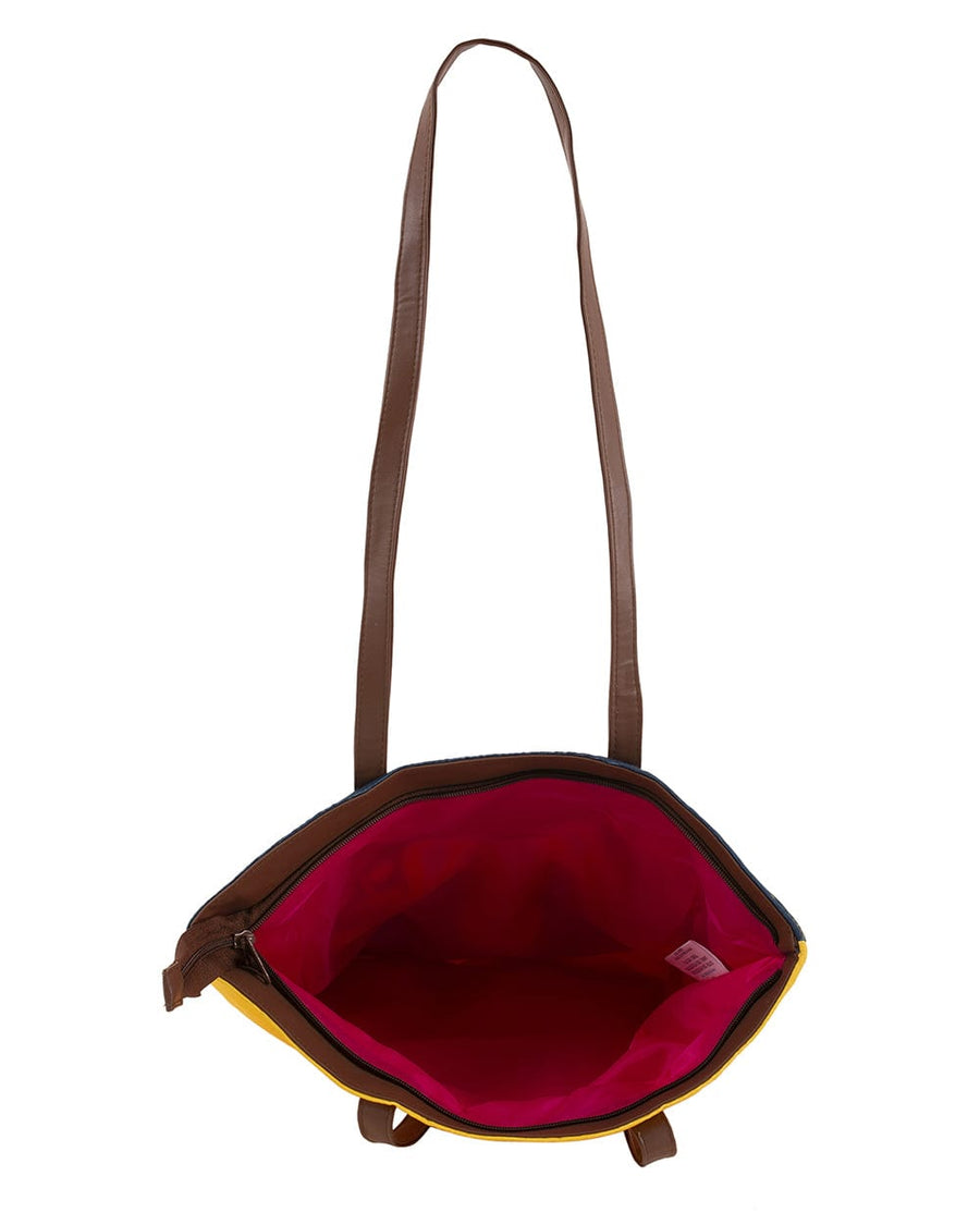 Top-down view showing open tote bag interior lined with vibrant pinkish-red fabric and zipper closure