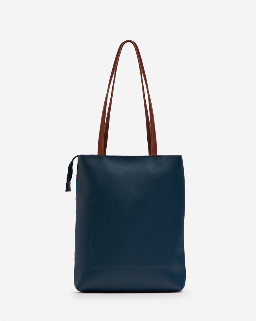 Rear view of solid navy tote bag with brown leather straps and clean finish