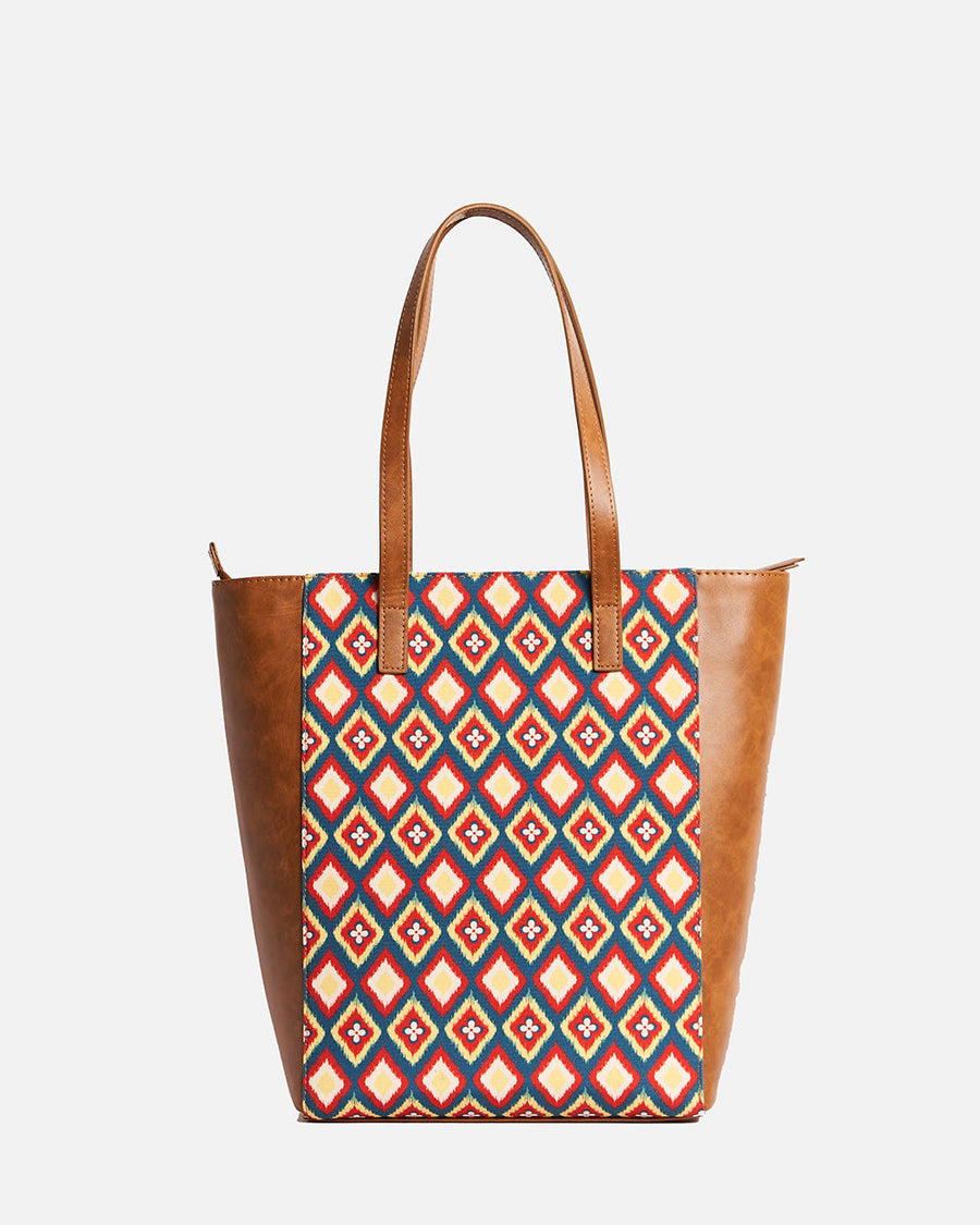 Front view of Teal by Chumbak tote bag featuring colorful diamond patterned embroidery and brown leather-like panels with two handles