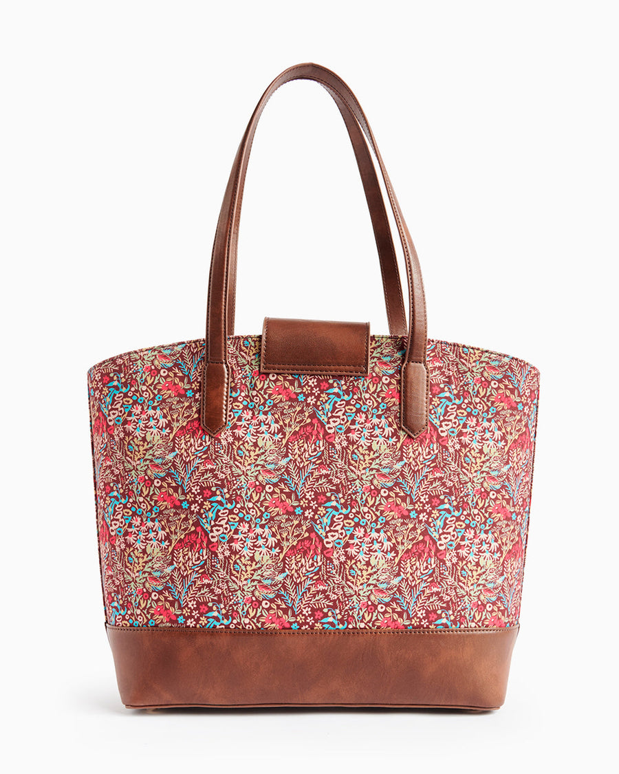 Back view of the floral tote bag with leather flap closure and long leather handles