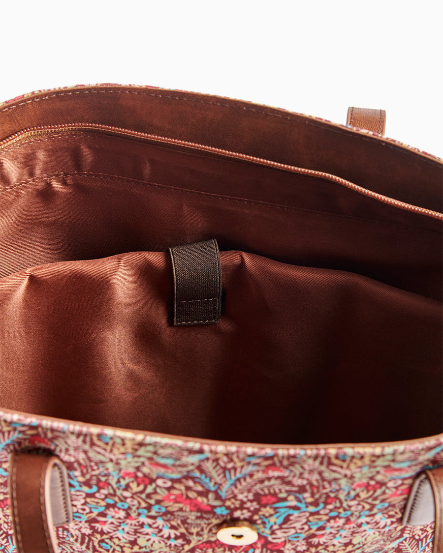 Close-up of the interior showing brown lining and laptop compartment with a secure strap
