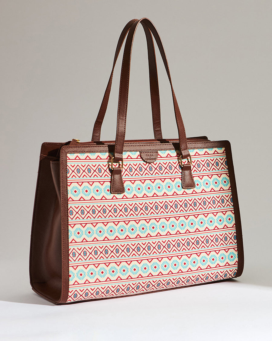 Side angle view of Aztec patterned office tote showcasing its structure, vegan leather side panels, and double handles