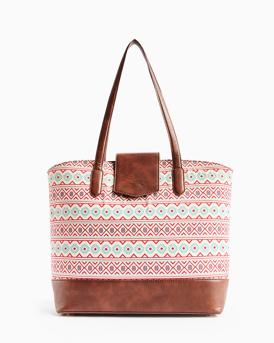 Front view of Aztec printed tote bag with brown faux leather base and flap handle detail