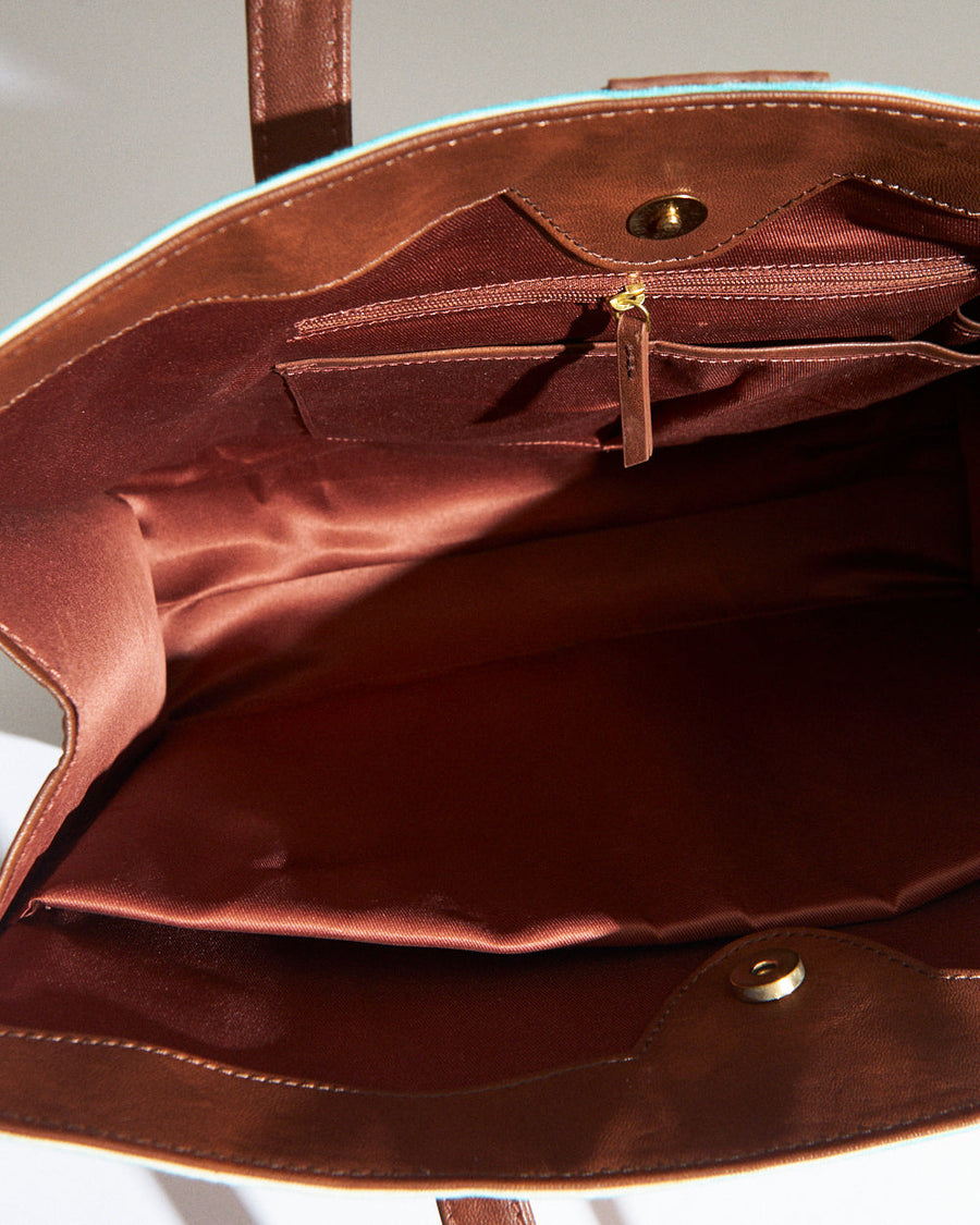 Open interior view showing spacious brown satin lining with zippered pocket and inner compartments