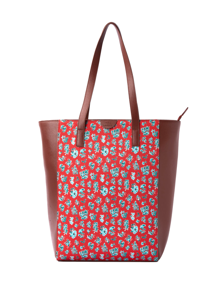 Front view of floral print canvas tote bag with brown vegan leather sides and double straps