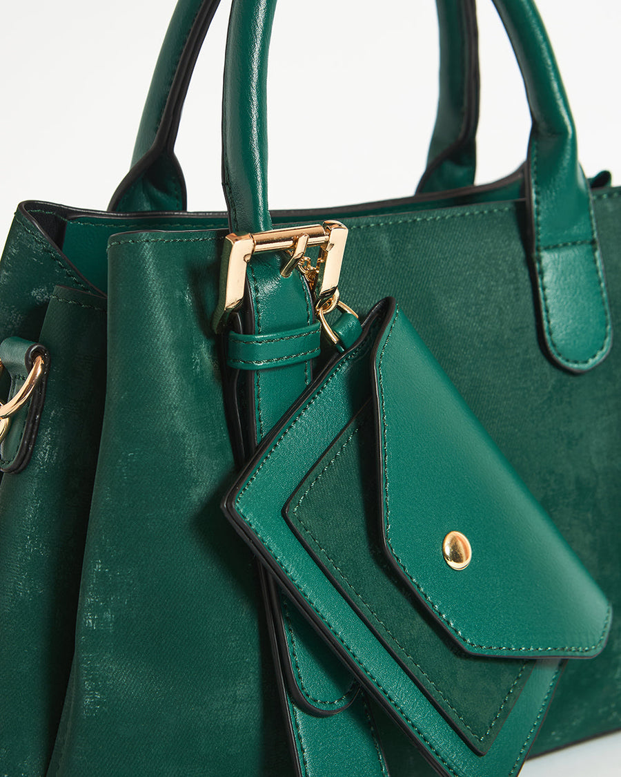Dimensions illustration of emerald handbag showing 9.5 inches width, 7.5 inches height, and 4 inches depth