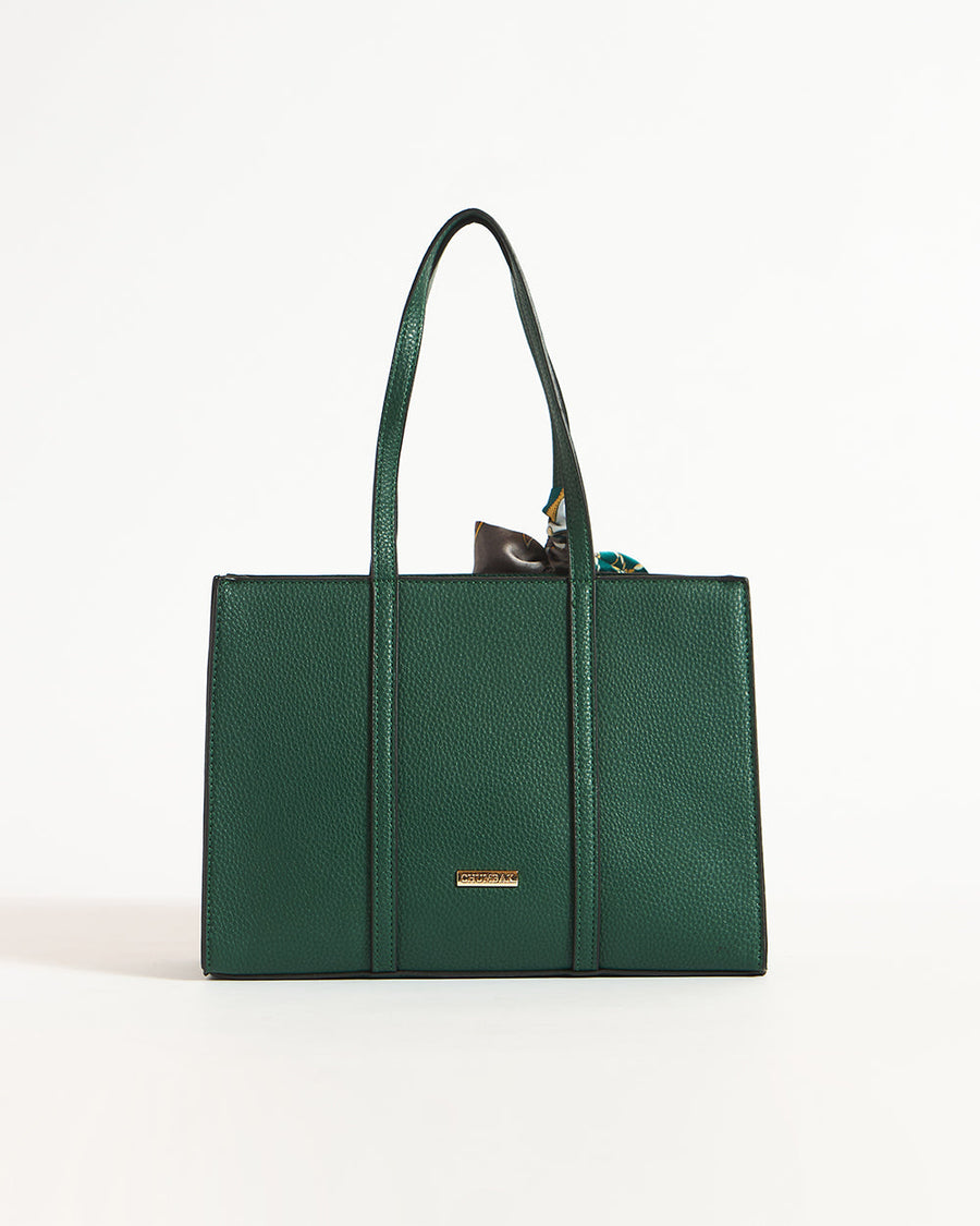 Front view of green mini tote bag with gold logo plate and printed scarf detail