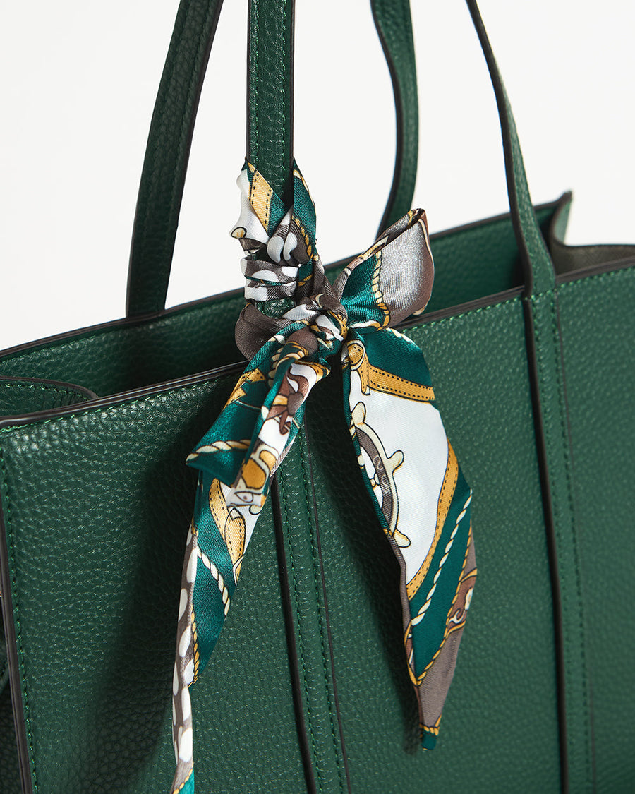 Interior pocket of green tote with brown wallet partially inserted