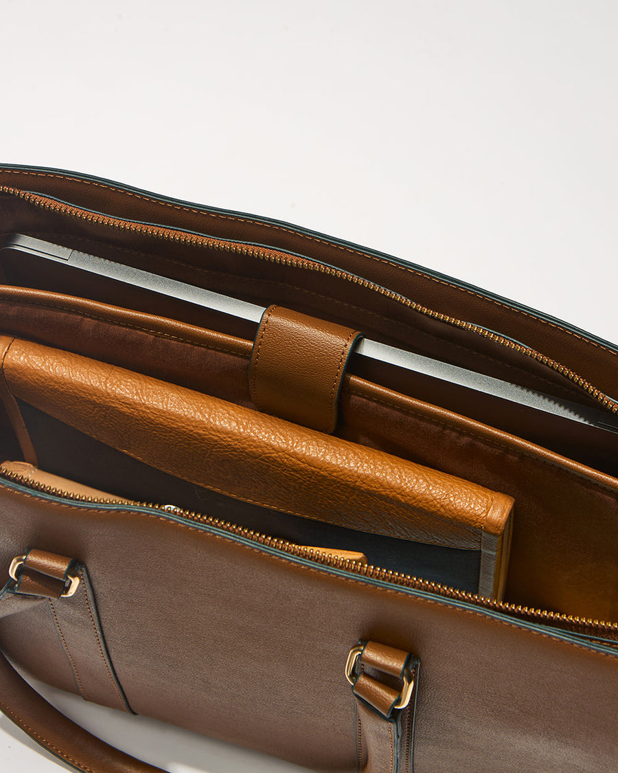 Top view of Kenya Tote bag interior showing padded laptop compartment with laptop secured inside