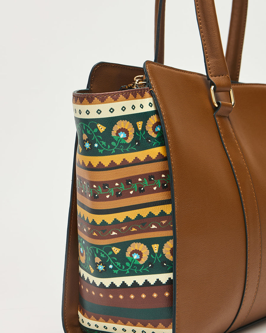 Close-up view of the Kenya Tote bag's floral-patterned side panel with green and yellow colors