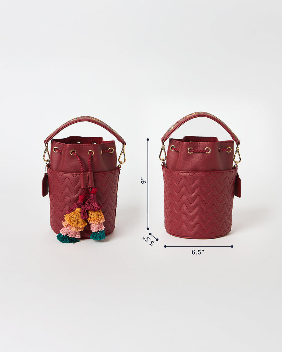 Dimension illustration of embroidered red bucket bag with height 9 inches and width 6.5 inches