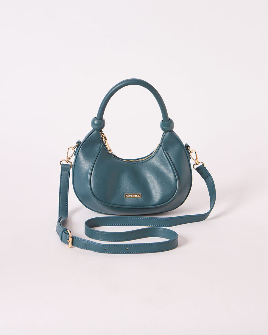 Front view of vegan leather crescent handbag with adjustable crossbody strap on white background