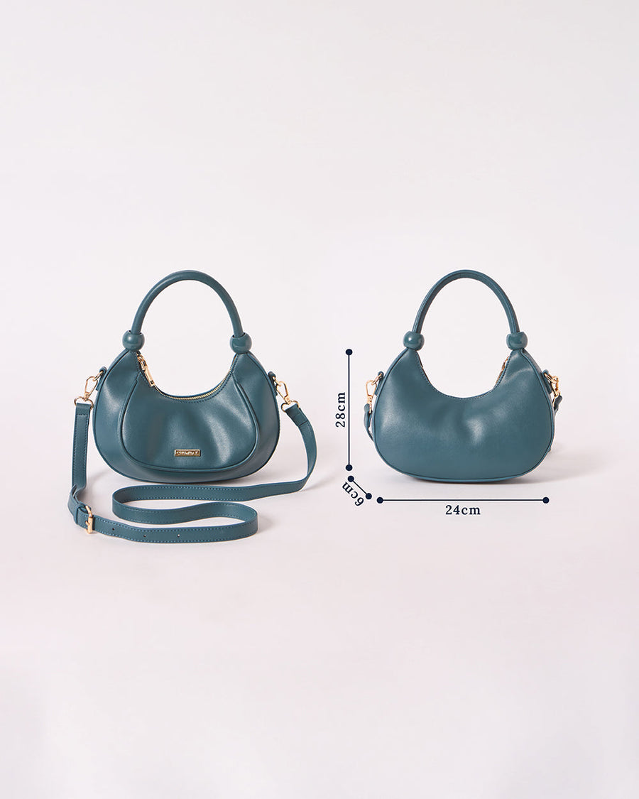 Front and back view of deep teal crescent handbag with measurements on white background
