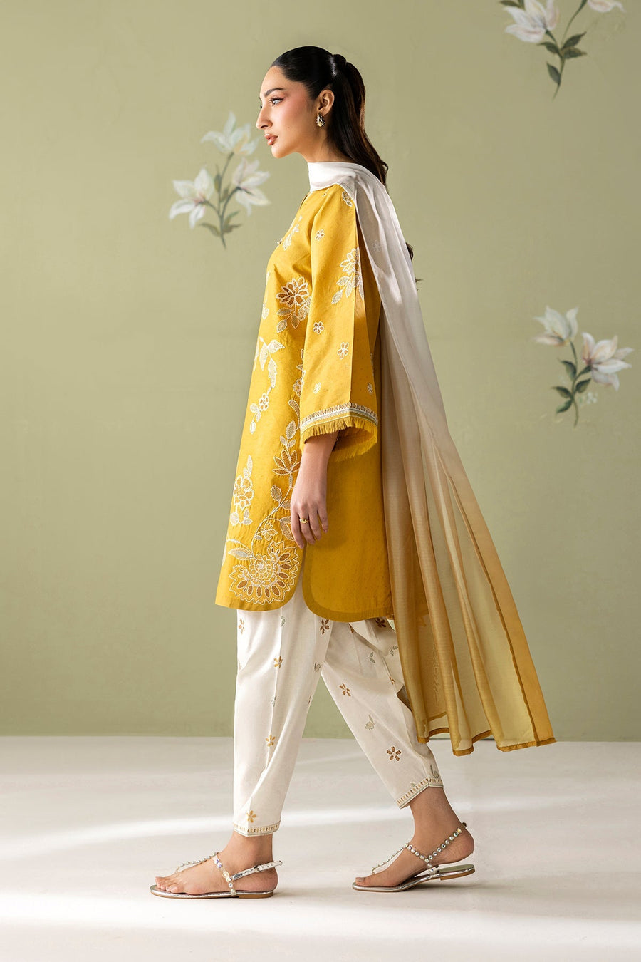Full front view of model standing with embroidered mustard yellow shirt, white pants, pearl earrings, rings, and ombré dupatta