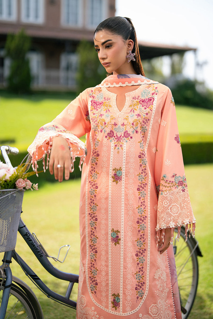 Detailed shot of upper body showing neckline embroidery and star-shaped earrings