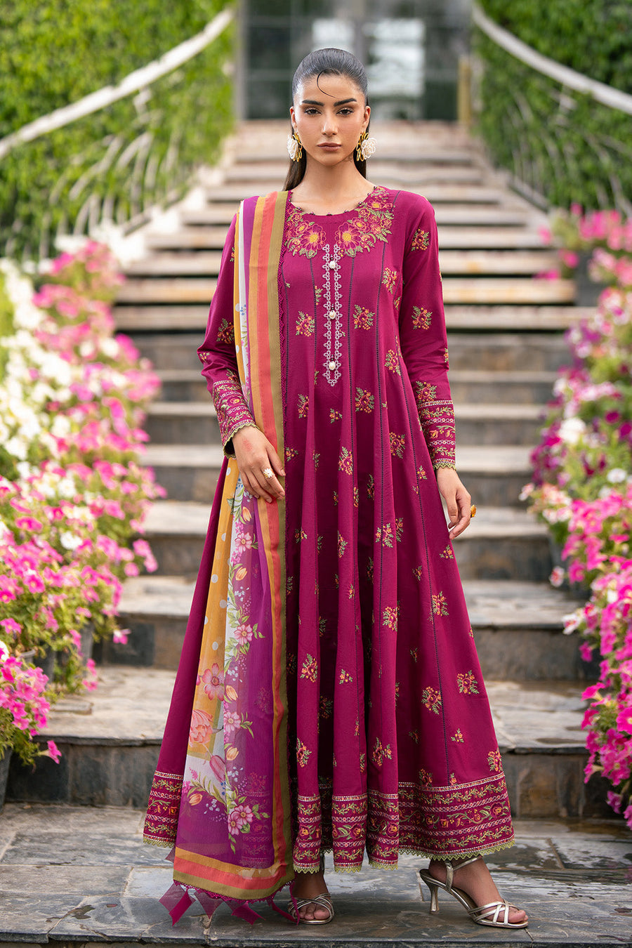 Front view of woman standing on steps in magenta embroidered floral maxi dress with printed dupatta