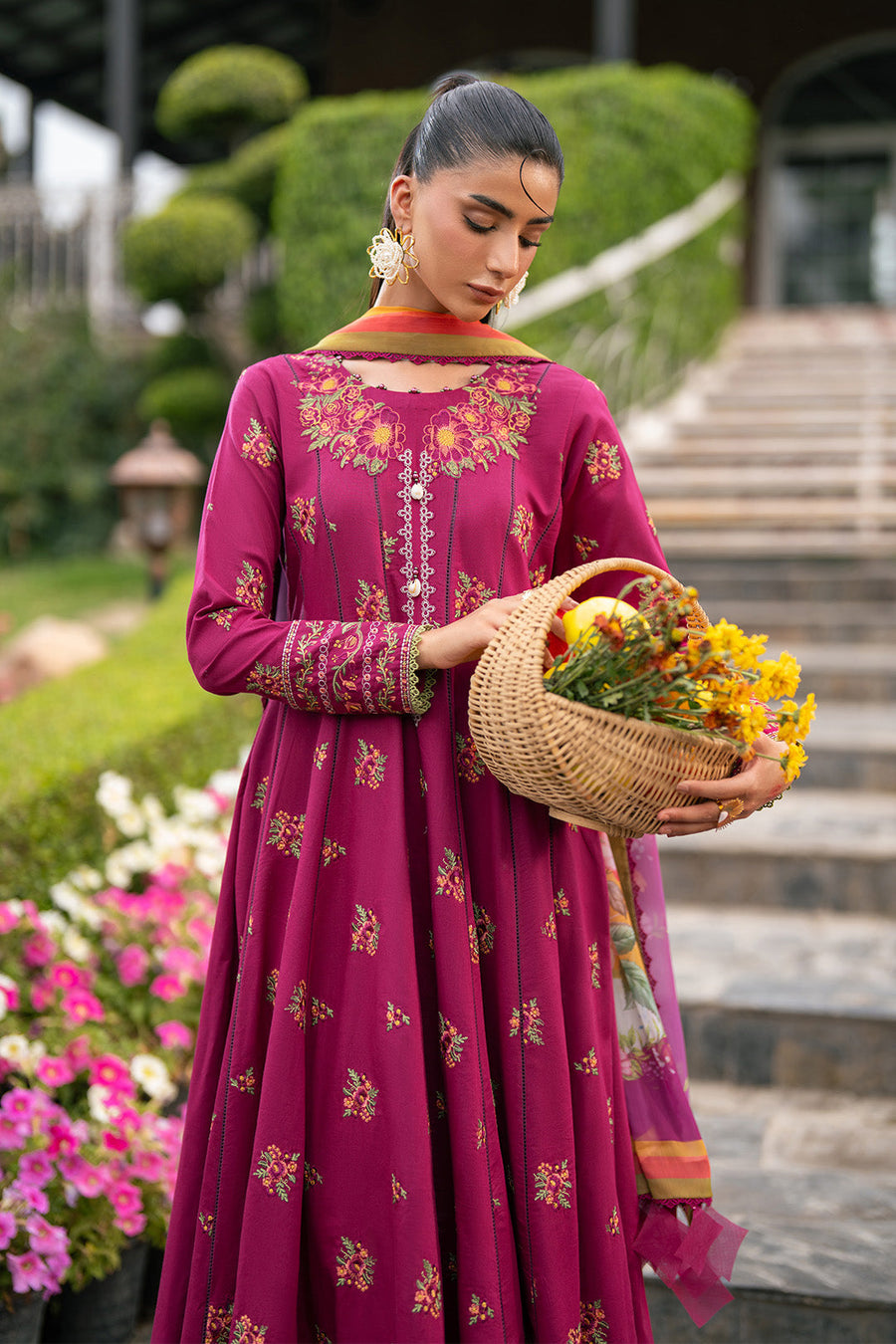 Close-up of front embroidery and pearl button detailing on magenta maxi dress