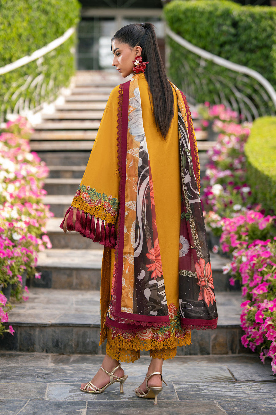 Back view of mustard yellow embroidered lawn suit showing plain dyed back and printed dupatta with floral pattern