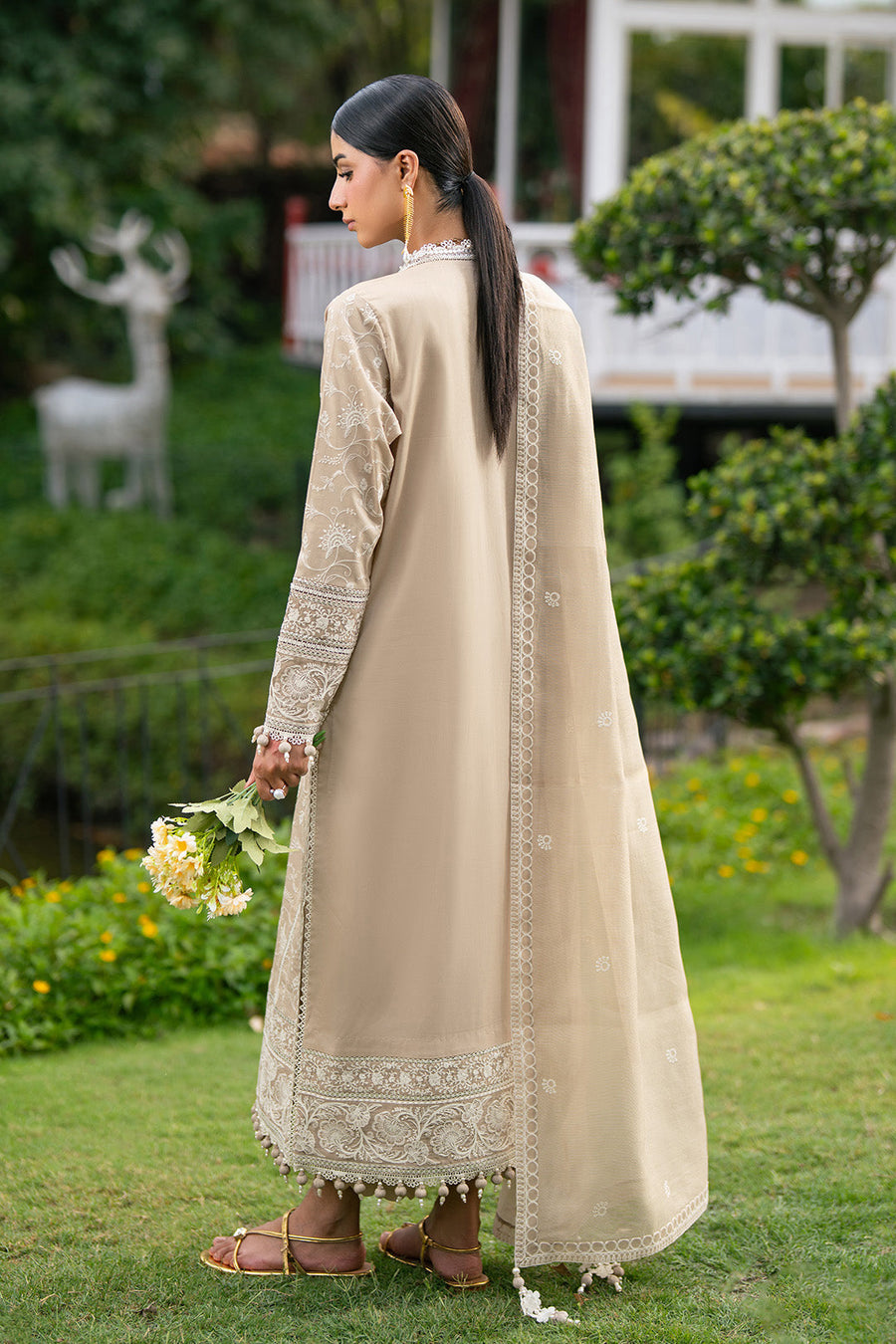 Back view showing plain dyed lawn back and embroidered border on sleeves and hem