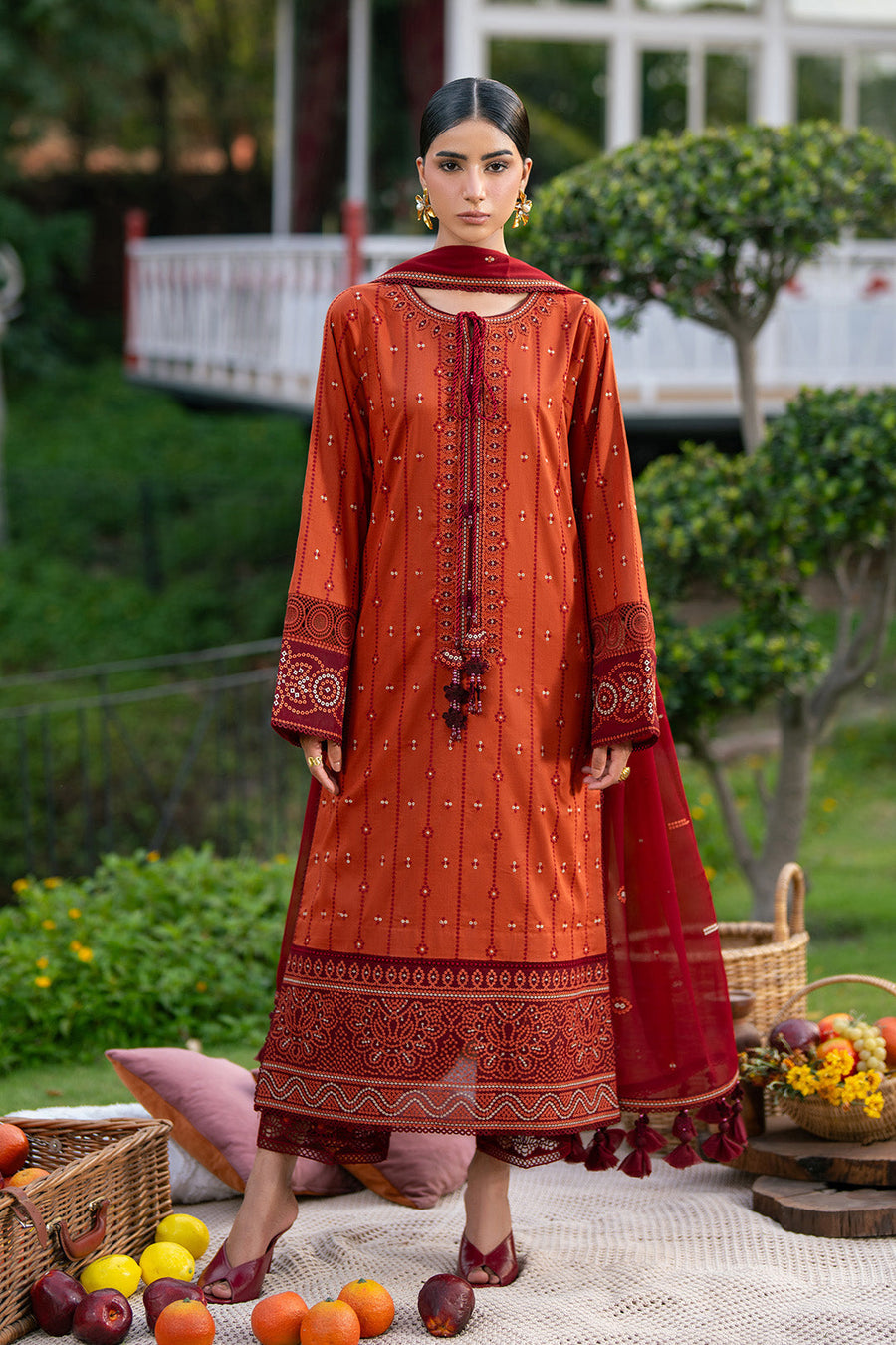 Detail of embroidered floral and geometric patterns on sleeves and lower hem