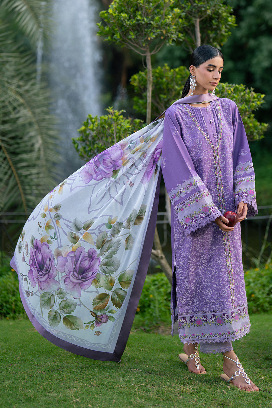 Model holding flowy floral printed chiffon dupatta with purple lawn suit