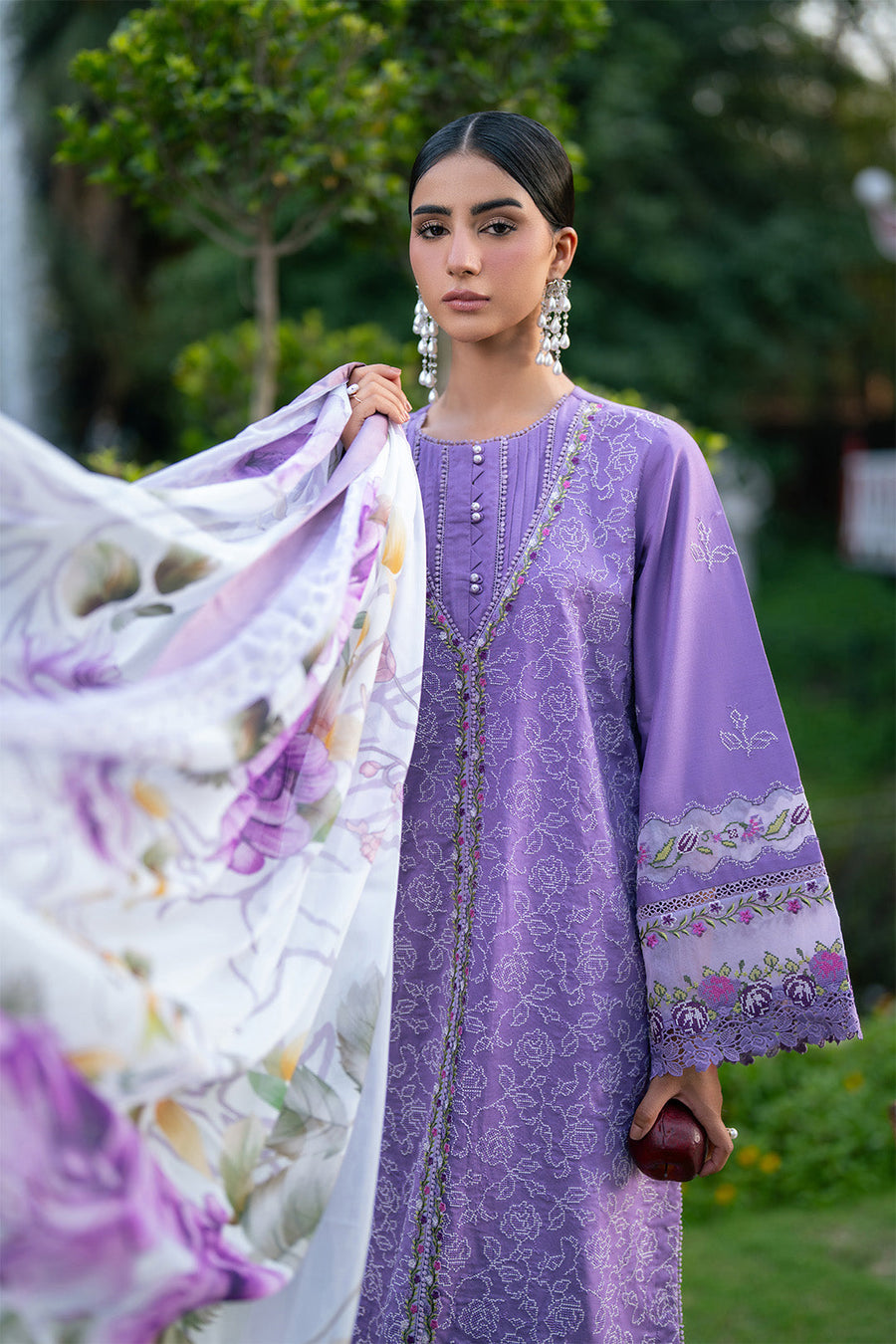 Close up of model showing detailed embroidery on front of lawn suit
